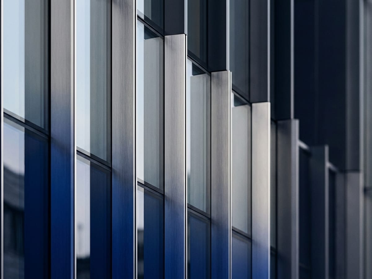 Abstract architectural detail echoing the 111 Wealth Group brand palette of royal blue and silver-gray.